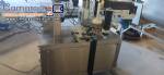 Automatic self-adhesive labeling machine for cylindrical bottles