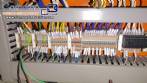 Pick and place product feeder for flowpack transfer cartoning machine
