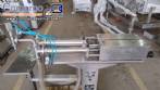Filling machine with 2 nozzles for liquids and pilfer cap screwer