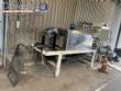 Automatic baling machine with shrink tunnel for bottles and jars in bales.