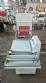 L-shaped packaging sealer with semi-automatic shrink tunnel.