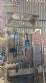 Labeling machine with steam sleeve tunnel and bottle baler