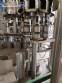 Zegla rotary filling machine with rinser and three-block capping system.