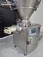 Handtmann vacuum stuffer with twister and tilting elevator, up to 6,000 kg per hour.